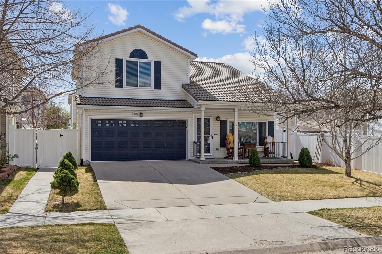 4983 Halifax Court Denver, CO 80249 - Photo 1 of 17 a view of front of house with yard