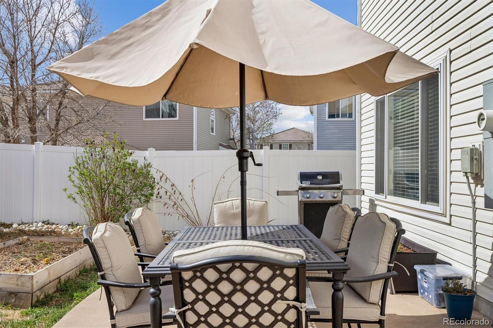 4983 Halifax Court Denver, CO 80249 - Photo 15 of 17 a view of a patio with table and chairs and potted plants