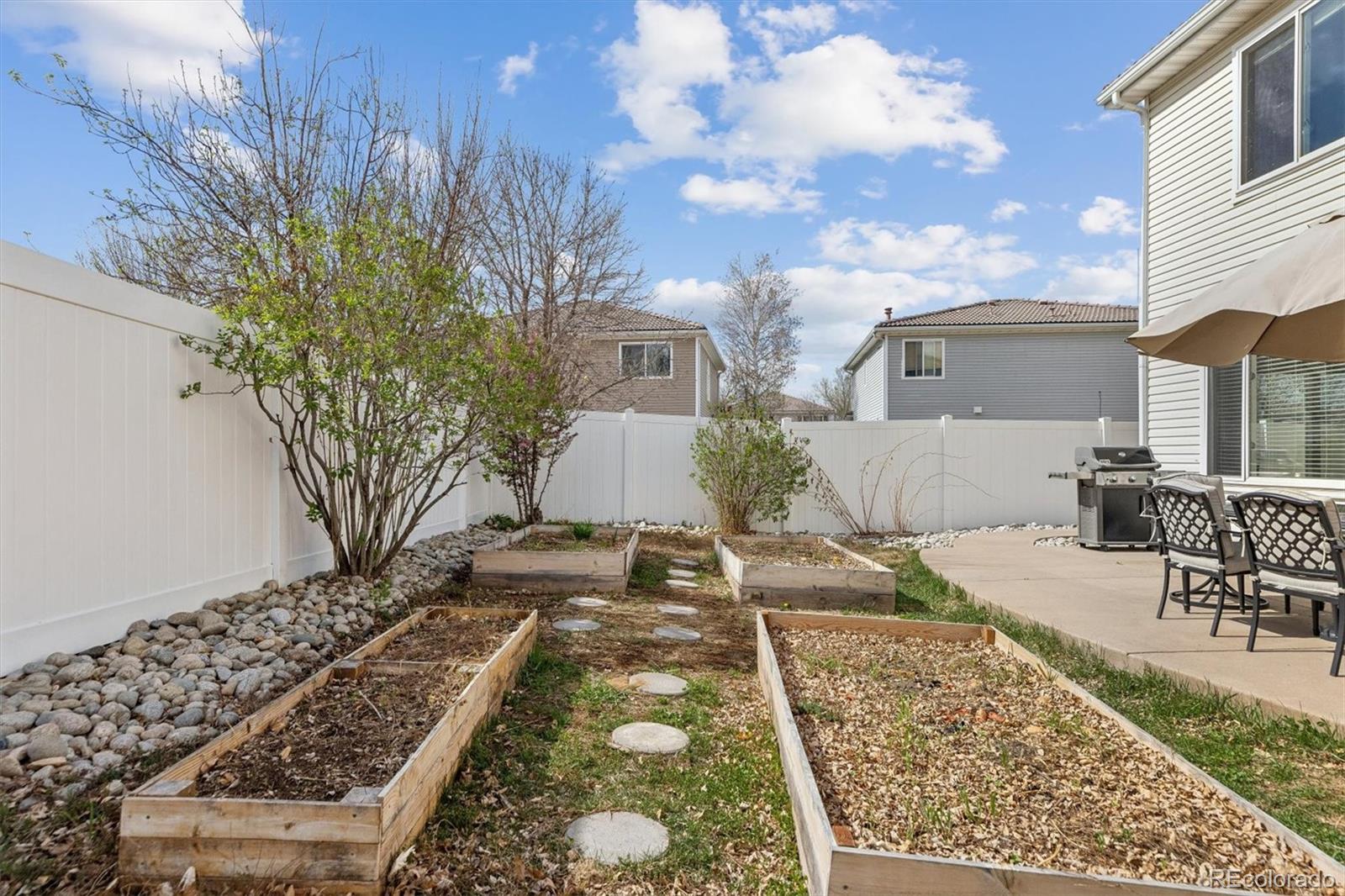 4983 Halifax Court Denver, CO 80249 - Photo 17 of 17 a view of a backyard with table and chairs