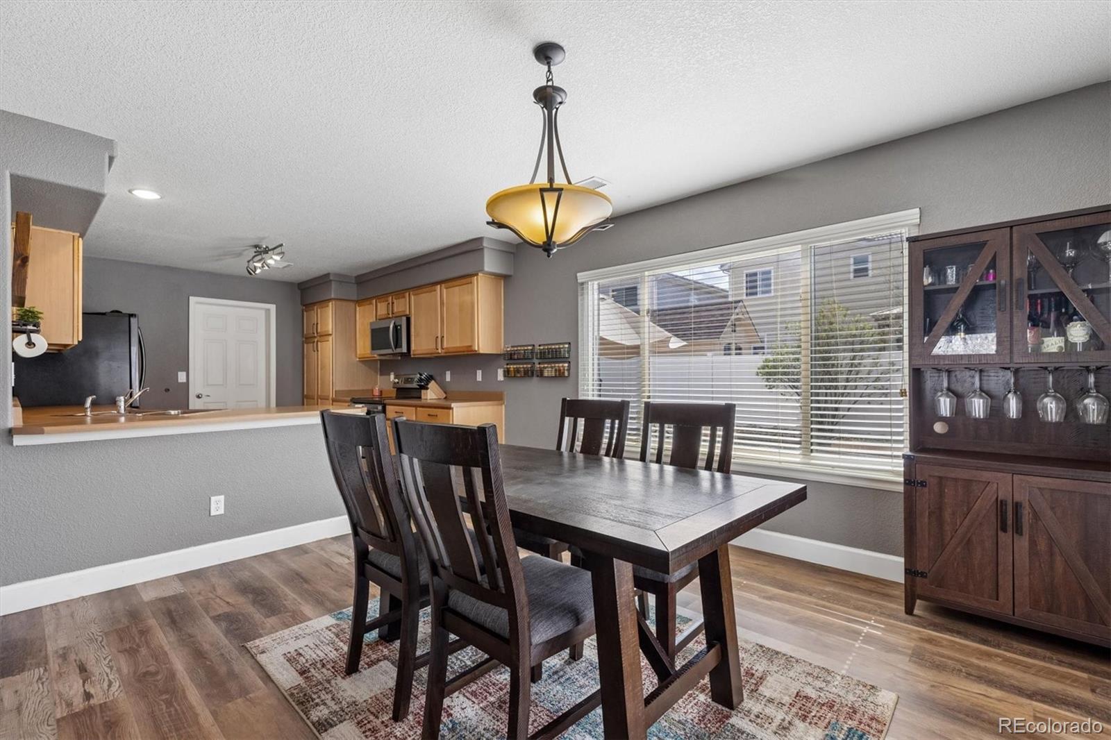 4983 Halifax Court Denver, CO 80249 - Photo 4 of 17 a dining room with furniture and window