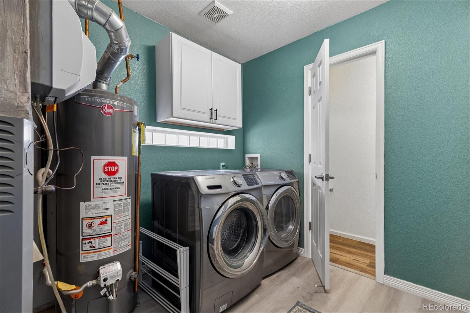 4983 Halifax Court Denver, CO 80249 - Photo 8 of 17 a utility room with dryer and washer