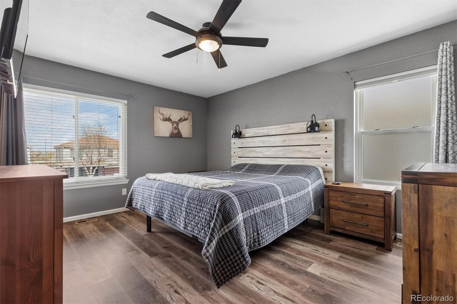 4983 Halifax Court Denver, CO 80249 - Photo 10 of 17 a bedroom with a large bed and a window