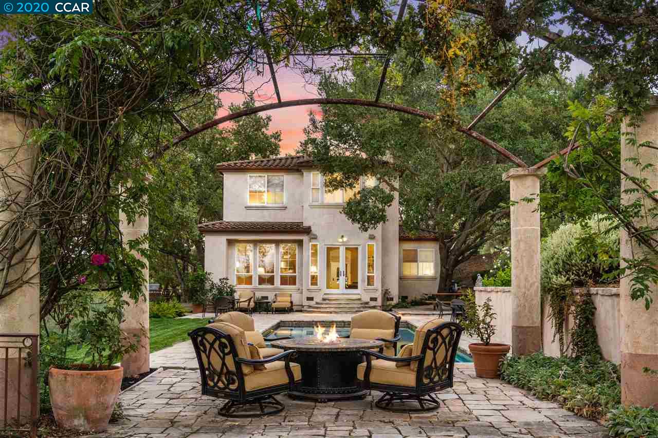a front view of a house with garden and sitting area