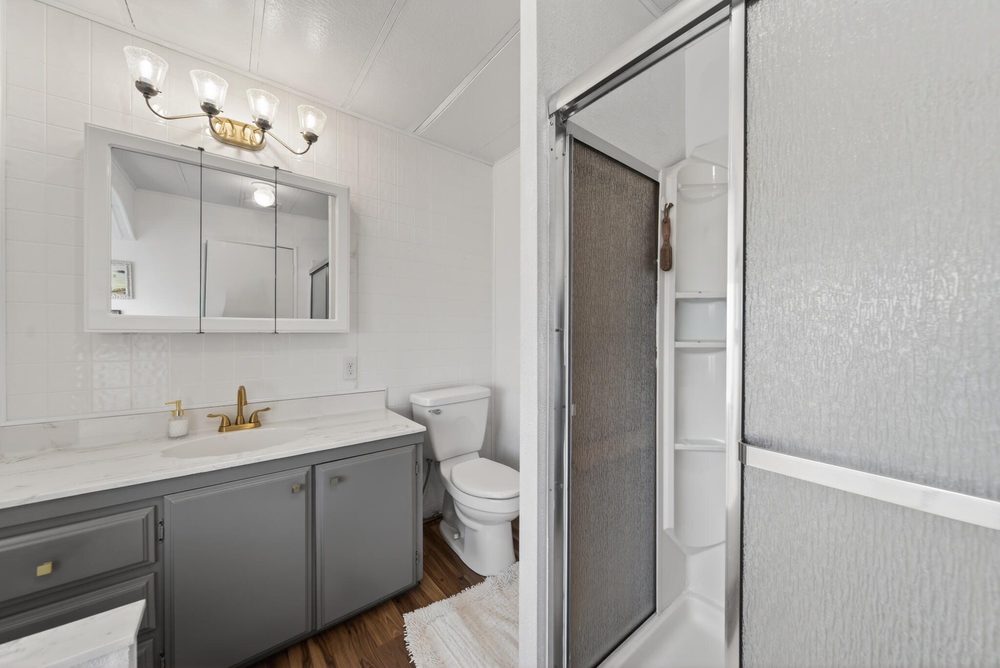 1059 Eagle Nest Road Redding, CA 96003 - Photo 12 of 44 a bathroom with a toilet sink and mirror
