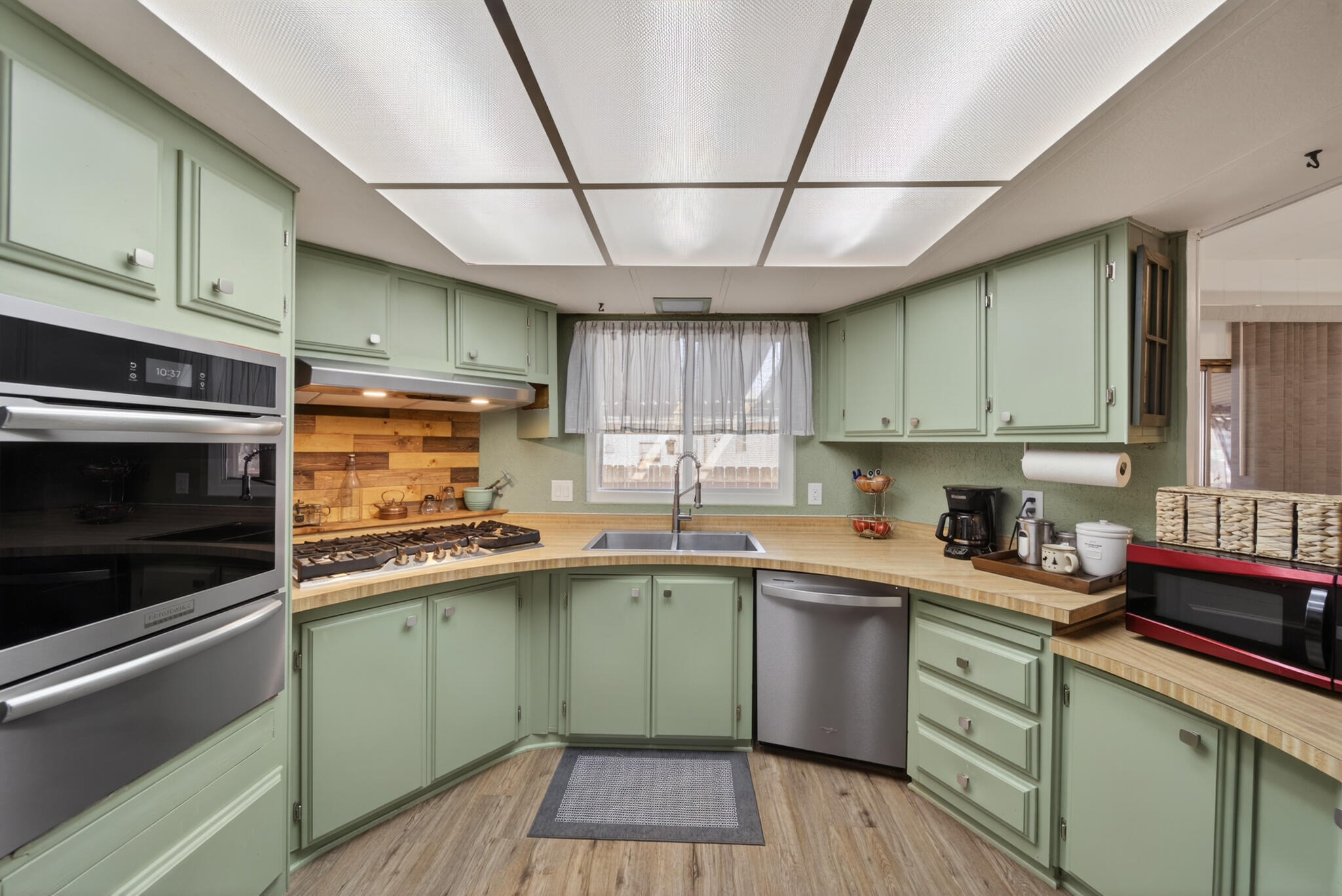 1059 Eagle Nest Road Redding, CA 96003 - Photo 18 of 44 a kitchen with a sink stainless steel appliances and cabinets
