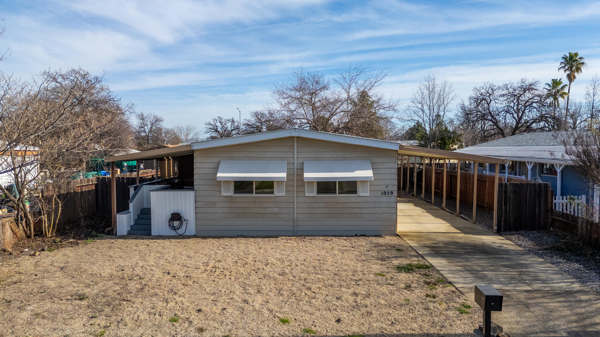 1059 Eagle Nest Road Redding, CA 96003 - Photo 30 of 44 a front view of house with yard and trees in the background