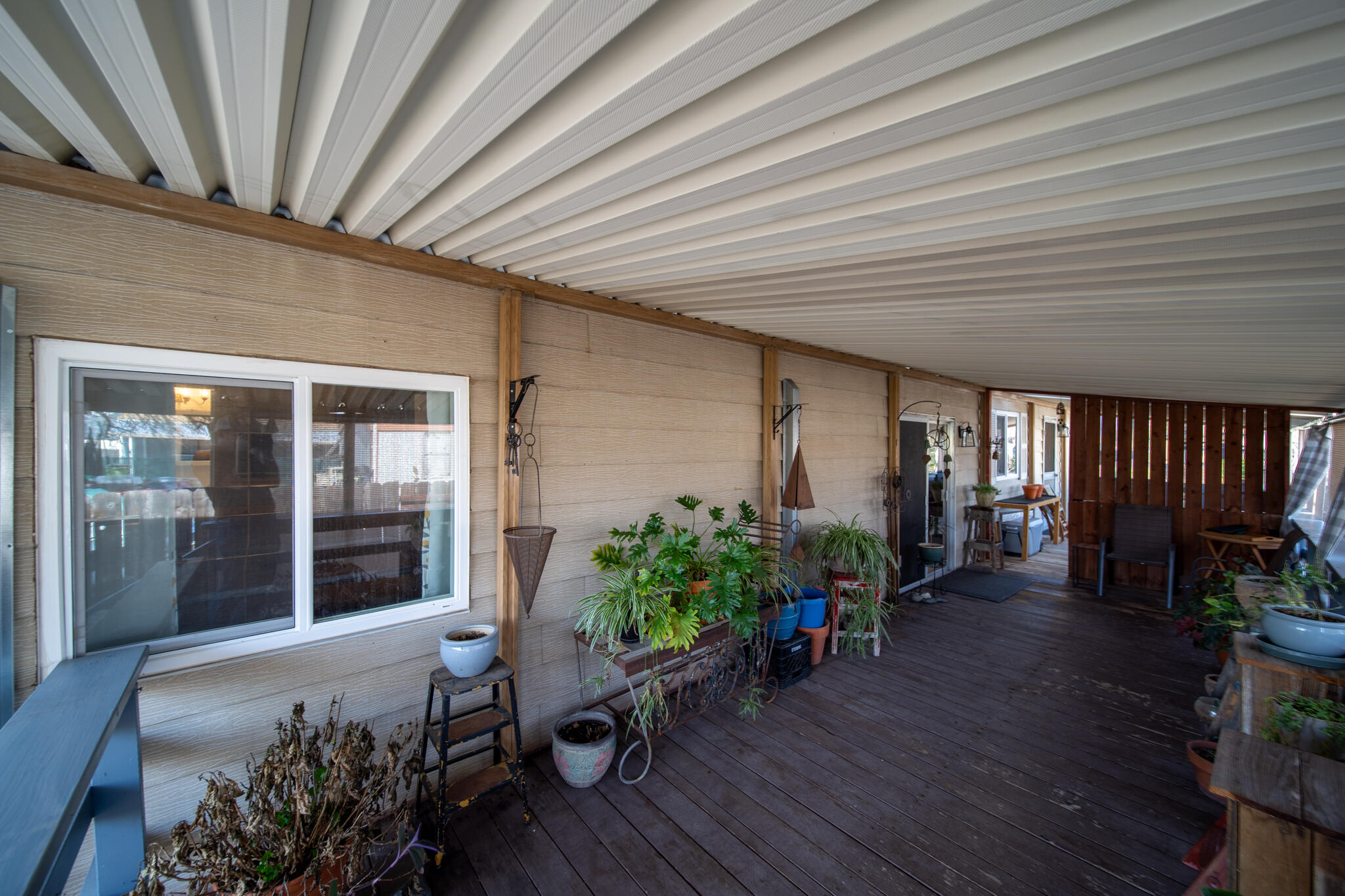 1059 Eagle Nest Road Redding, CA 96003 - Photo 40 of 44 a hallway with wooden bench plants and wooden floor