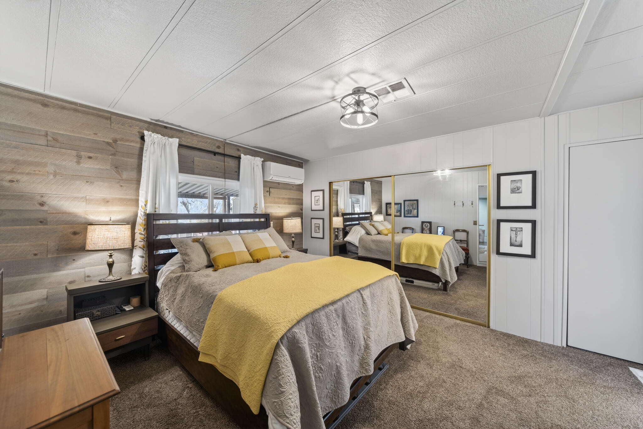 1059 Eagle Nest Road Redding, CA 96003 - Photo 8 of 44 a large bedroom with a bed and a chandelier