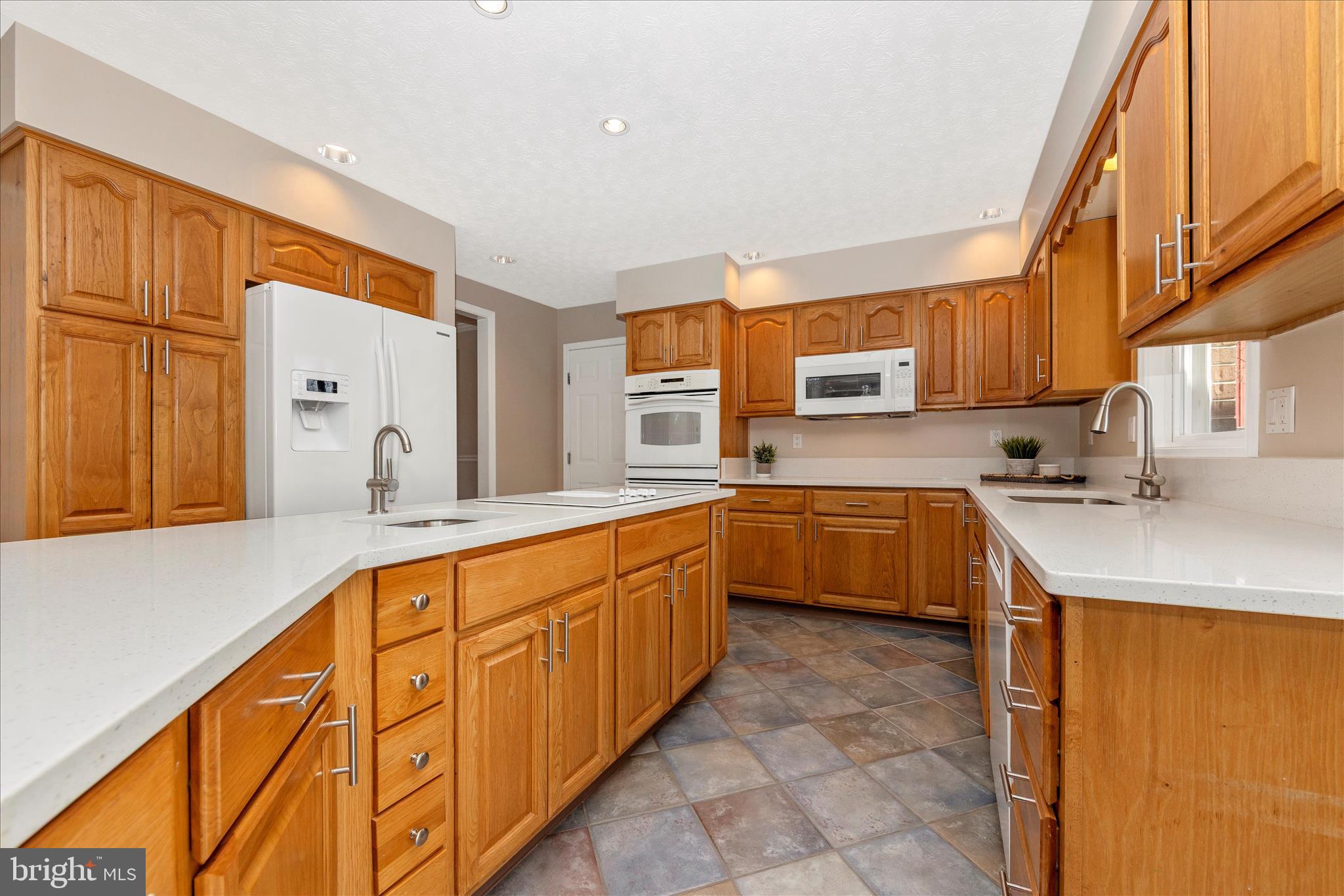 14695 Oak Orchard Road New Windsor, MD 21776 - Photo 12 of 57 a large kitchen with stainless steel appliances granite countertop a sink and cabinets