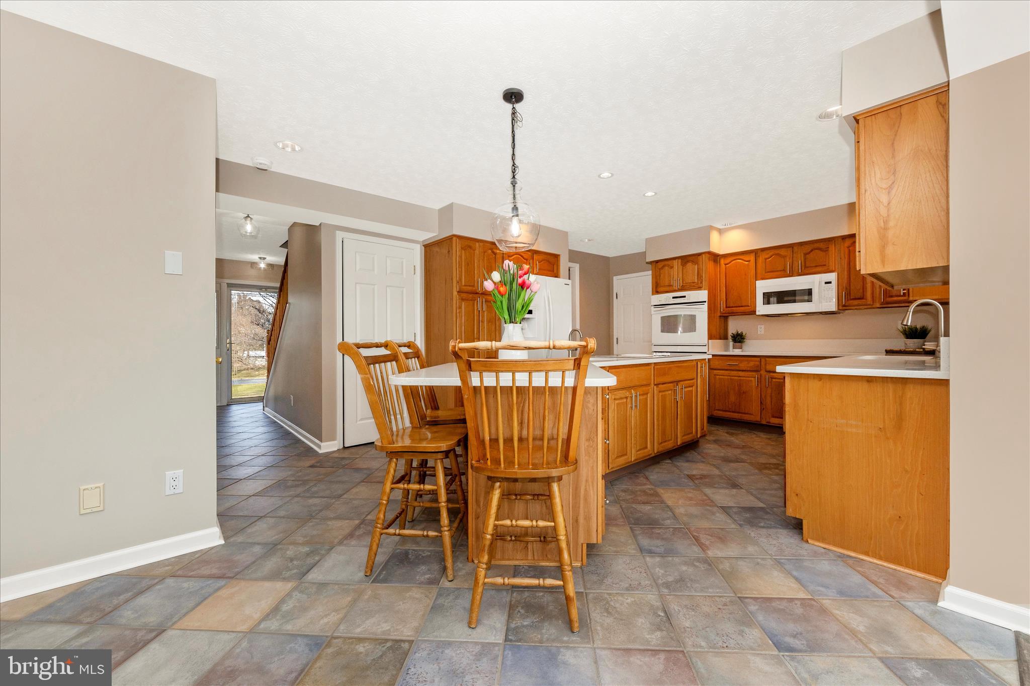 14695 Oak Orchard Road New Windsor, MD 21776 - Photo 19 of 57 a dining room filled a chandelier and kitchen view