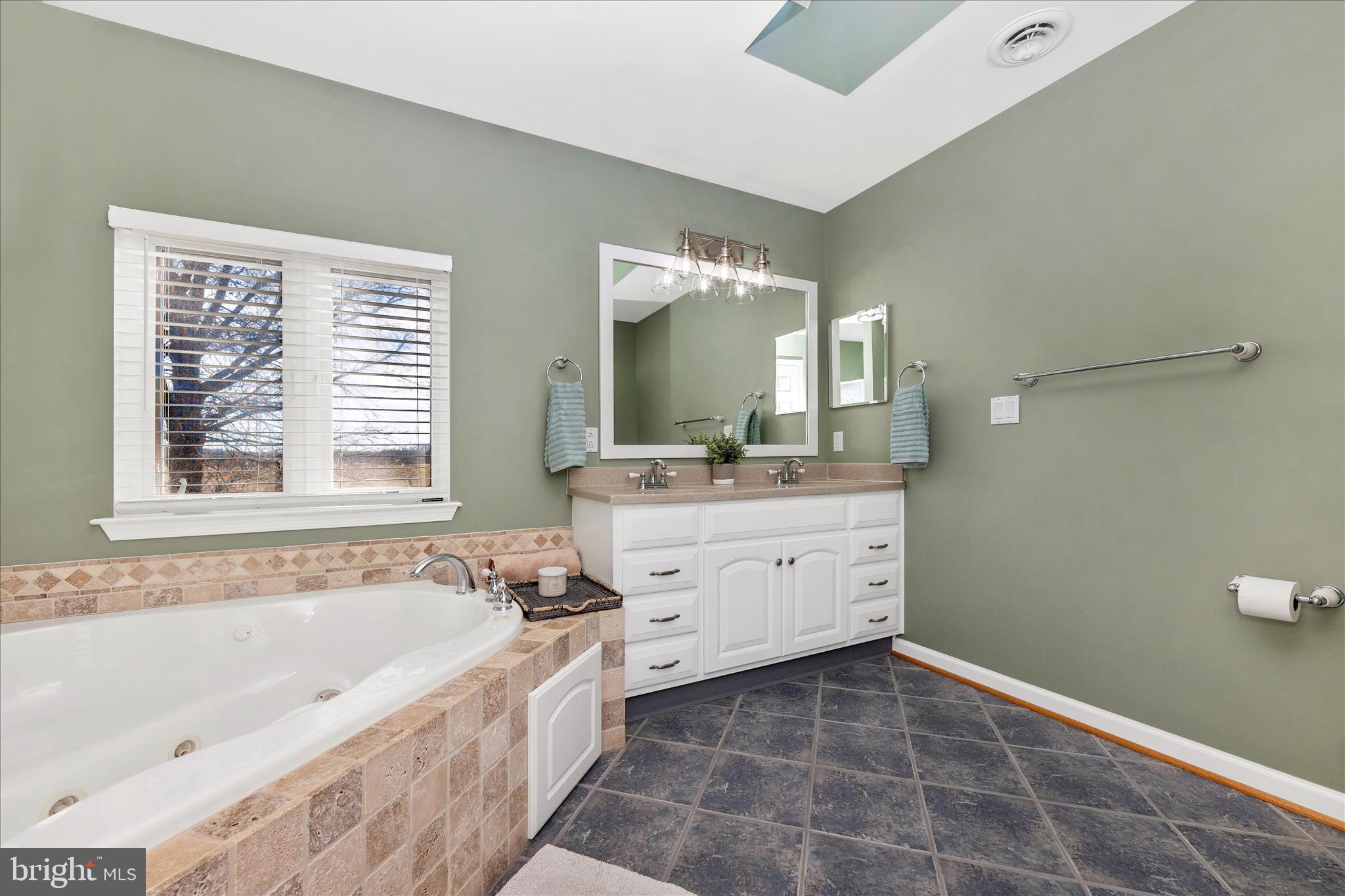 14695 Oak Orchard Road New Windsor, MD 21776 - Photo 30 of 57 a spacious bathroom with a bathtub sink and mirror