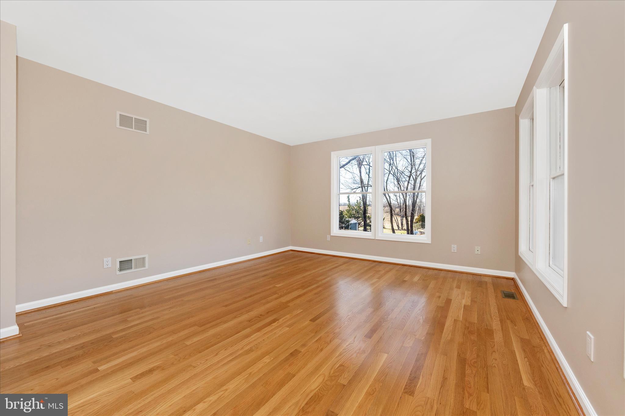 14695 Oak Orchard Road New Windsor, MD 21776 - Photo 3 of 57 an empty room with wooden floor and windows
