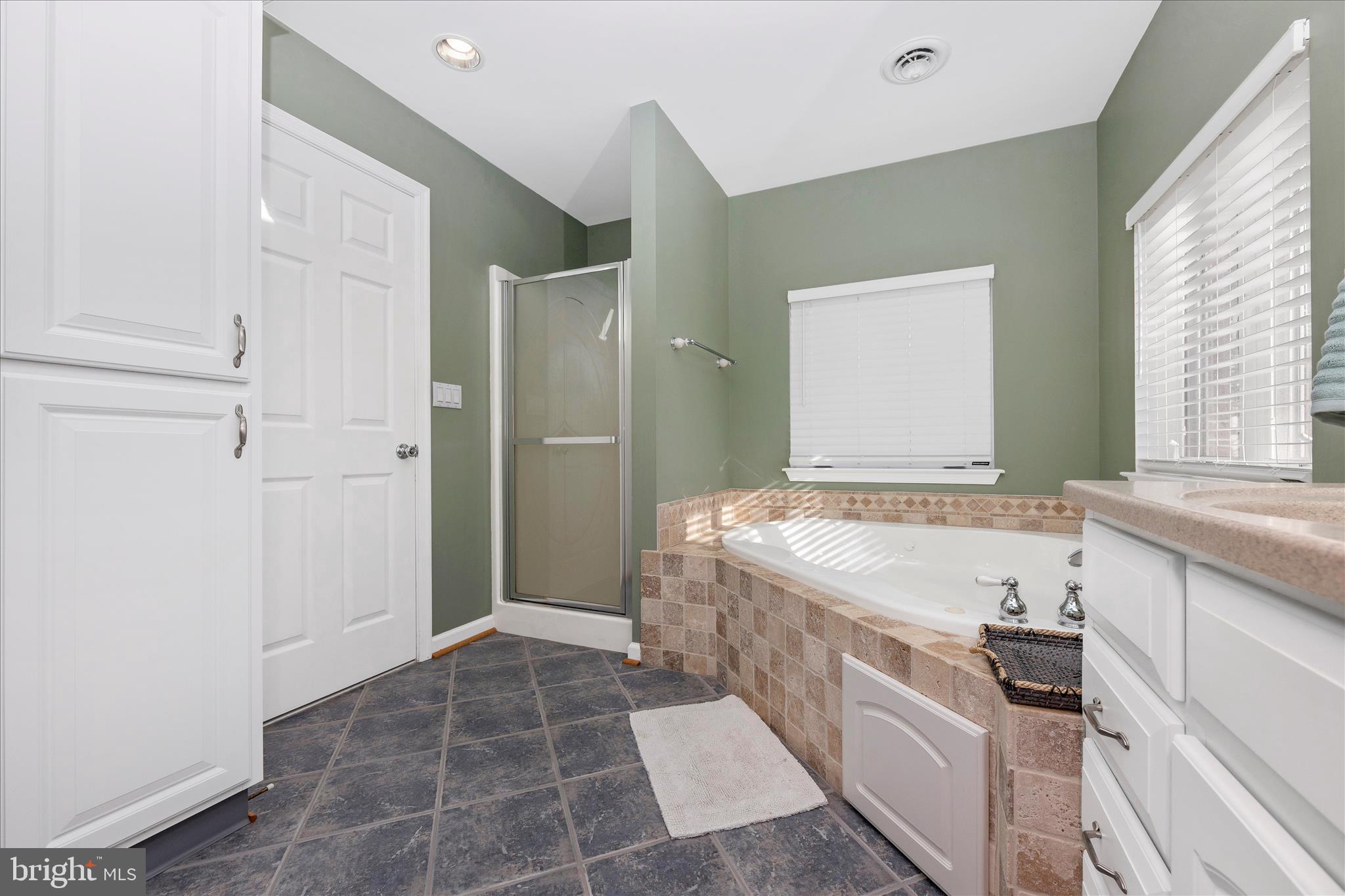 14695 Oak Orchard Road New Windsor, MD 21776 - Photo 32 of 57 a spacious bathroom with a granite countertop tub sink and mirror