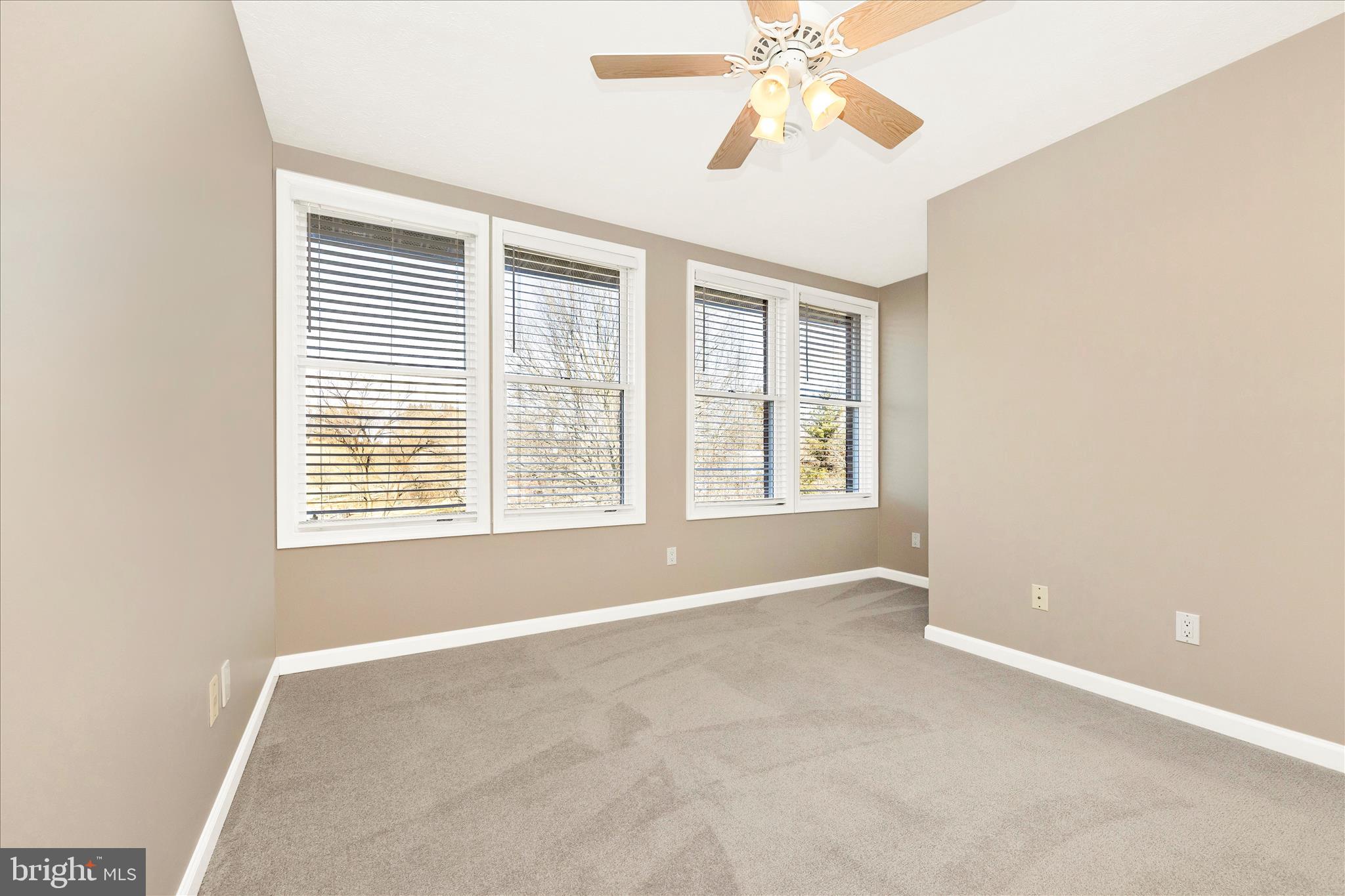 14695 Oak Orchard Road New Windsor, MD 21776 - Photo 36 of 57 an empty room with windows and chandelier fan