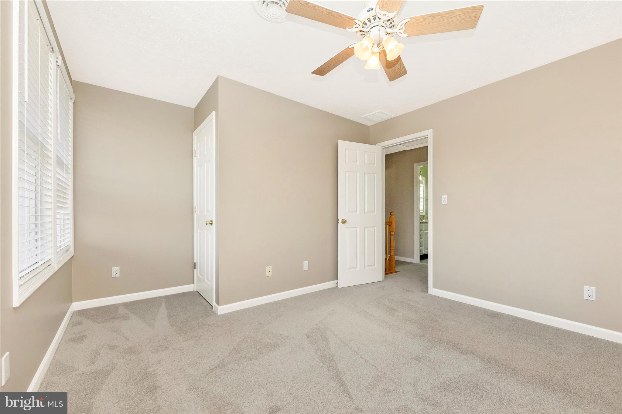 14695 Oak Orchard Road New Windsor, MD 21776 - Photo 37 of 57 a view of an empty room with chandelier fan and a window