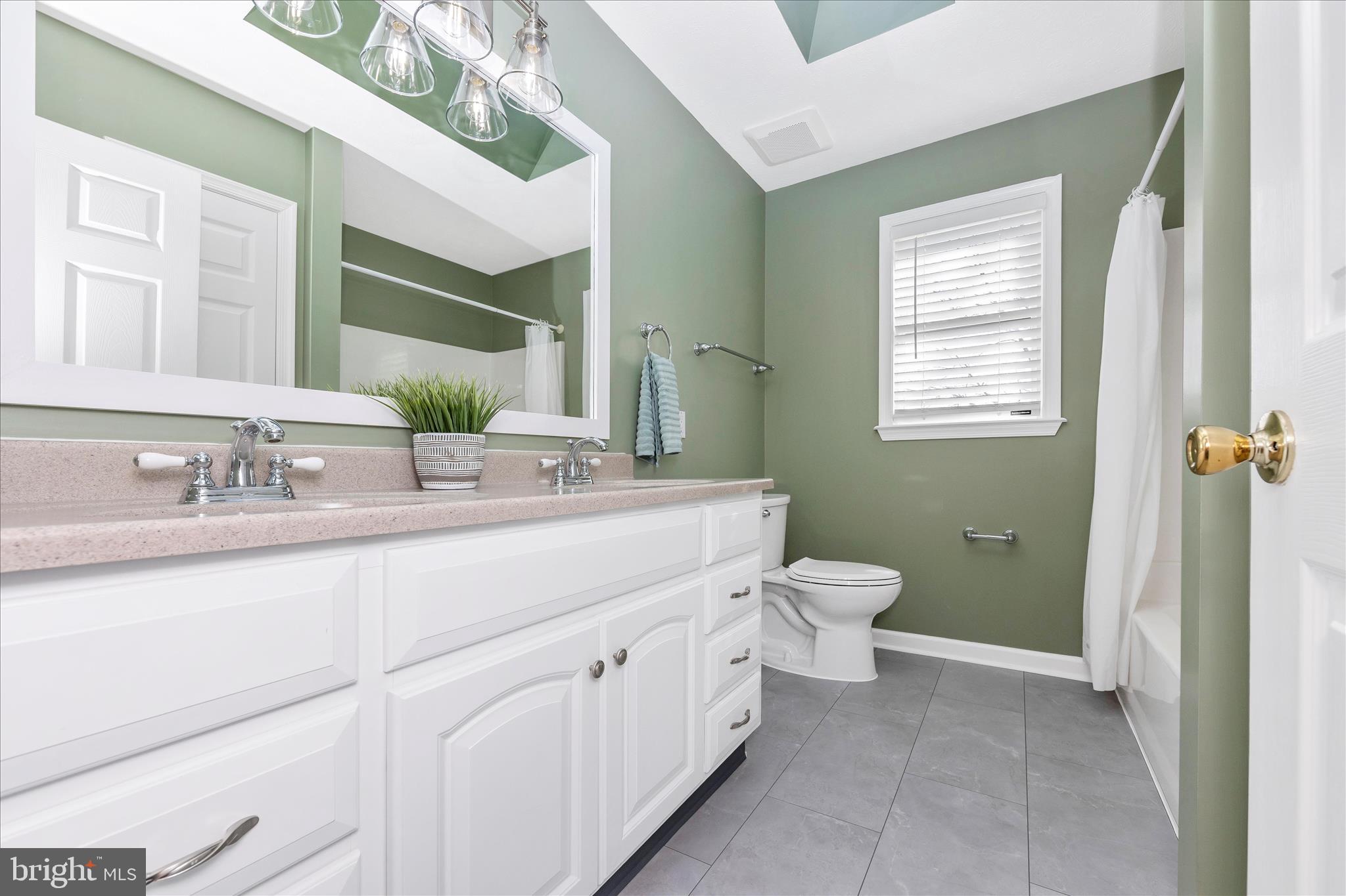 14695 Oak Orchard Road New Windsor, MD 21776 - Photo 38 of 57 a bathroom with a double vanity sink a toilet and a mirror