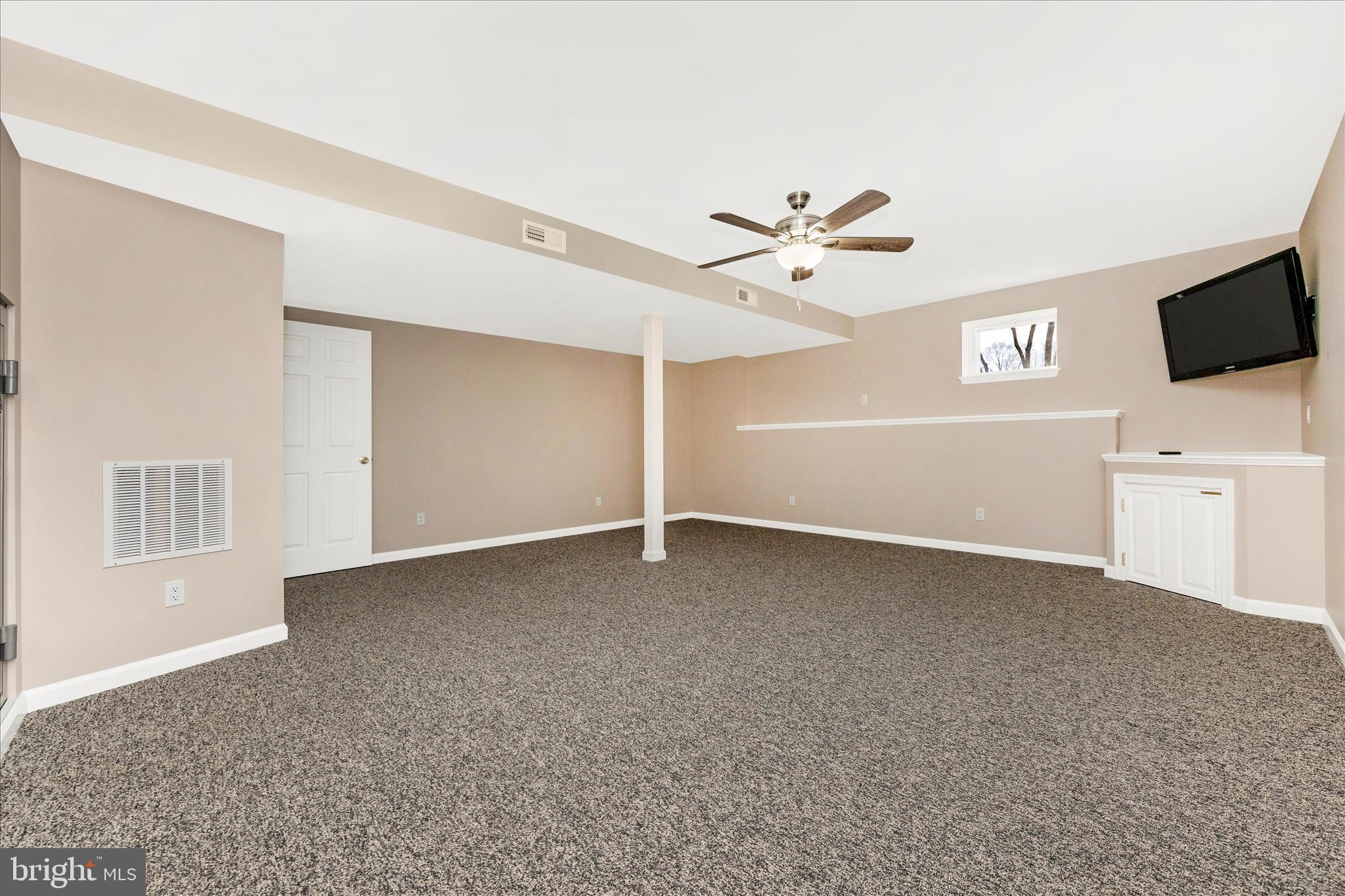 14695 Oak Orchard Road New Windsor, MD 21776 - Photo 41 of 57 a view of a livingroom with a ceiling fan and window