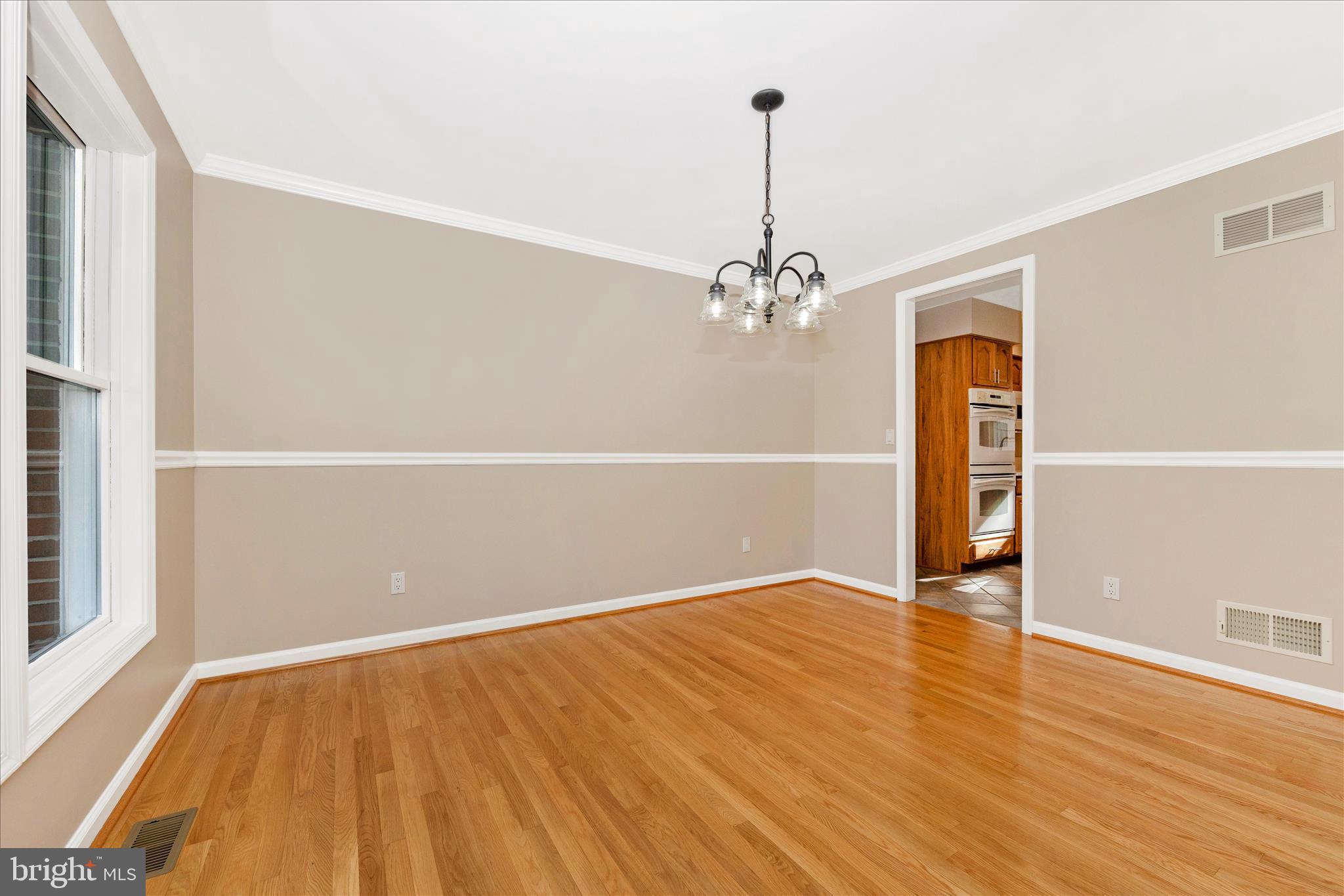 14695 Oak Orchard Road New Windsor, MD 21776 - Photo 8 of 57 a view of an empty room with wooden floor and a window
