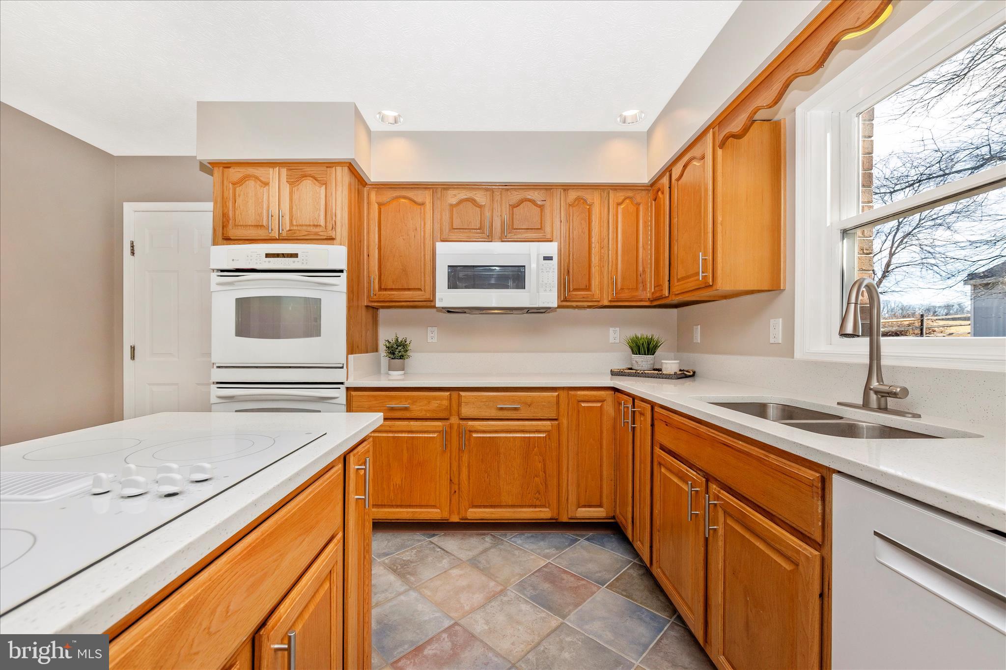 14695 Oak Orchard Road New Windsor, MD 21776 - Photo 10 of 57 a kitchen with stainless steel appliances granite countertop a sink and dishwasher a stove with wooden cabinets