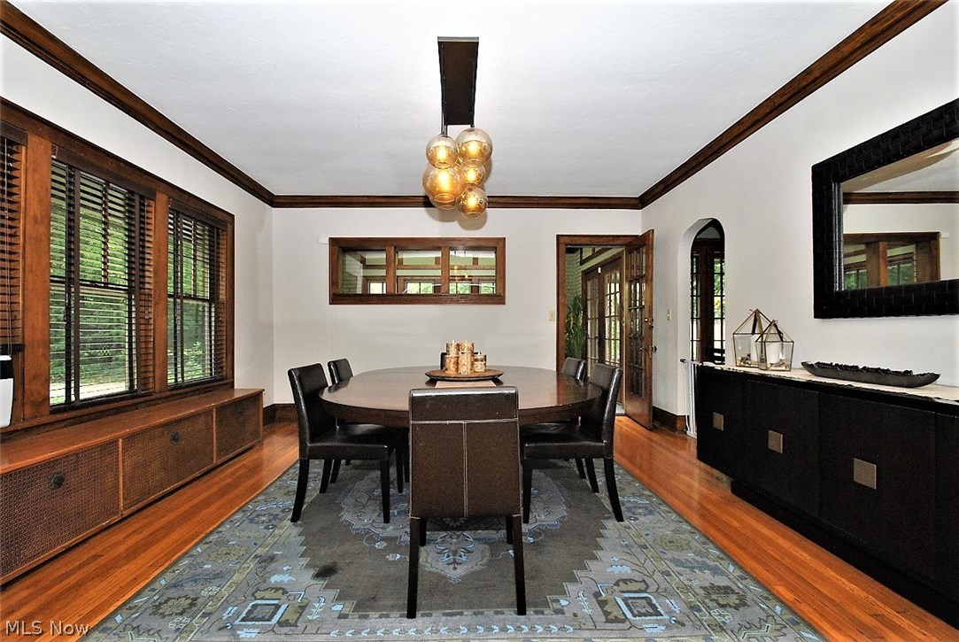 Formal dining room opens to living room and kitchen.  Wall of windows and wood flooring.