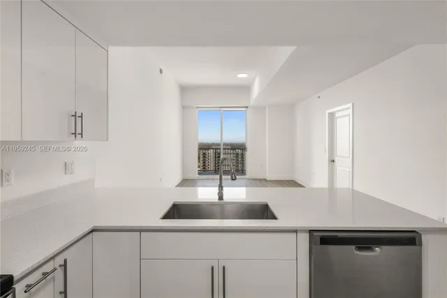 a kitchen with a sink and cabinets