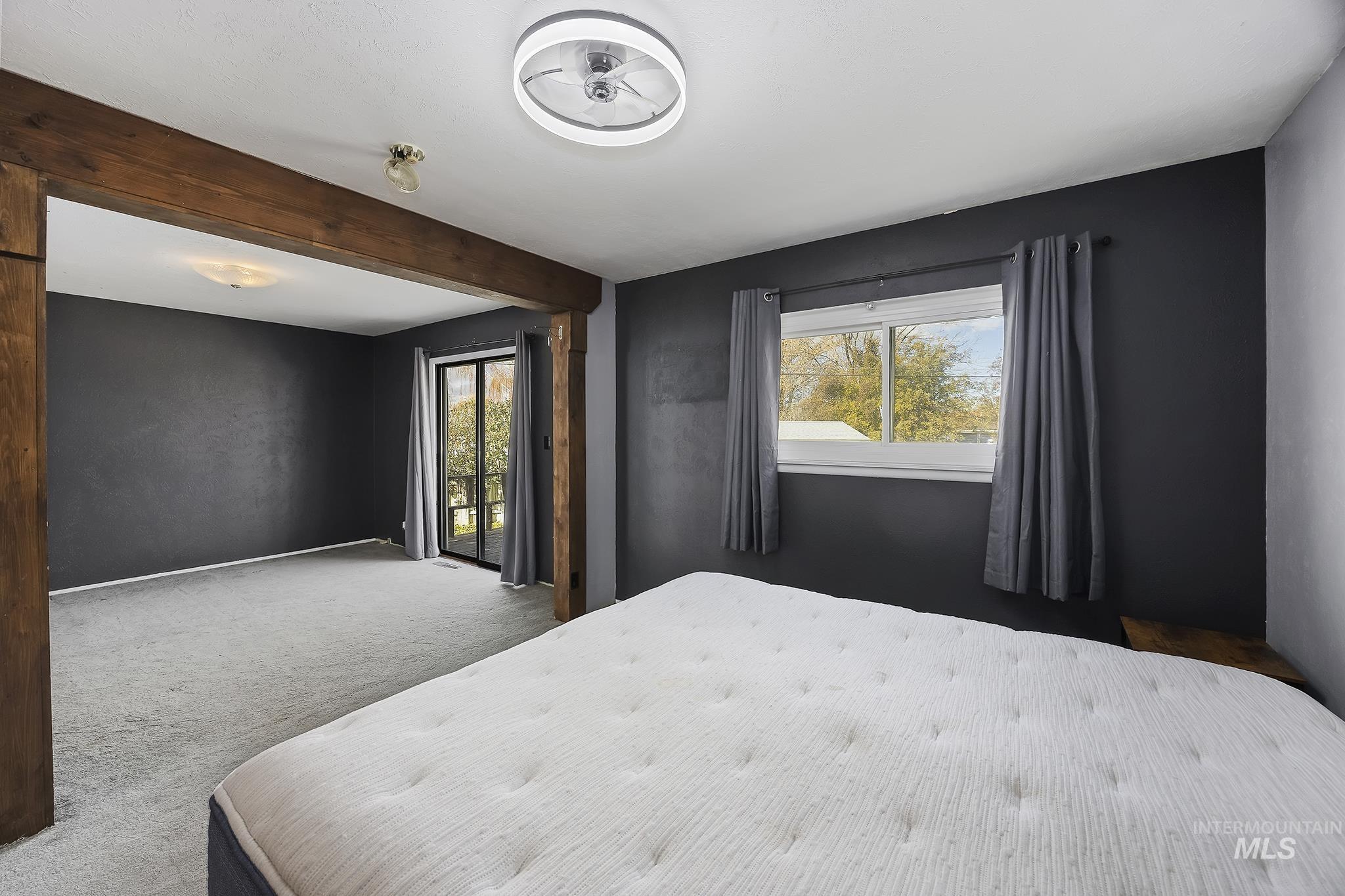 320 East 23rd Drive Burley, ID 83318 - Photo 17 of 34 Bedroom with beam ceiling, access to outside, and carpet flooring