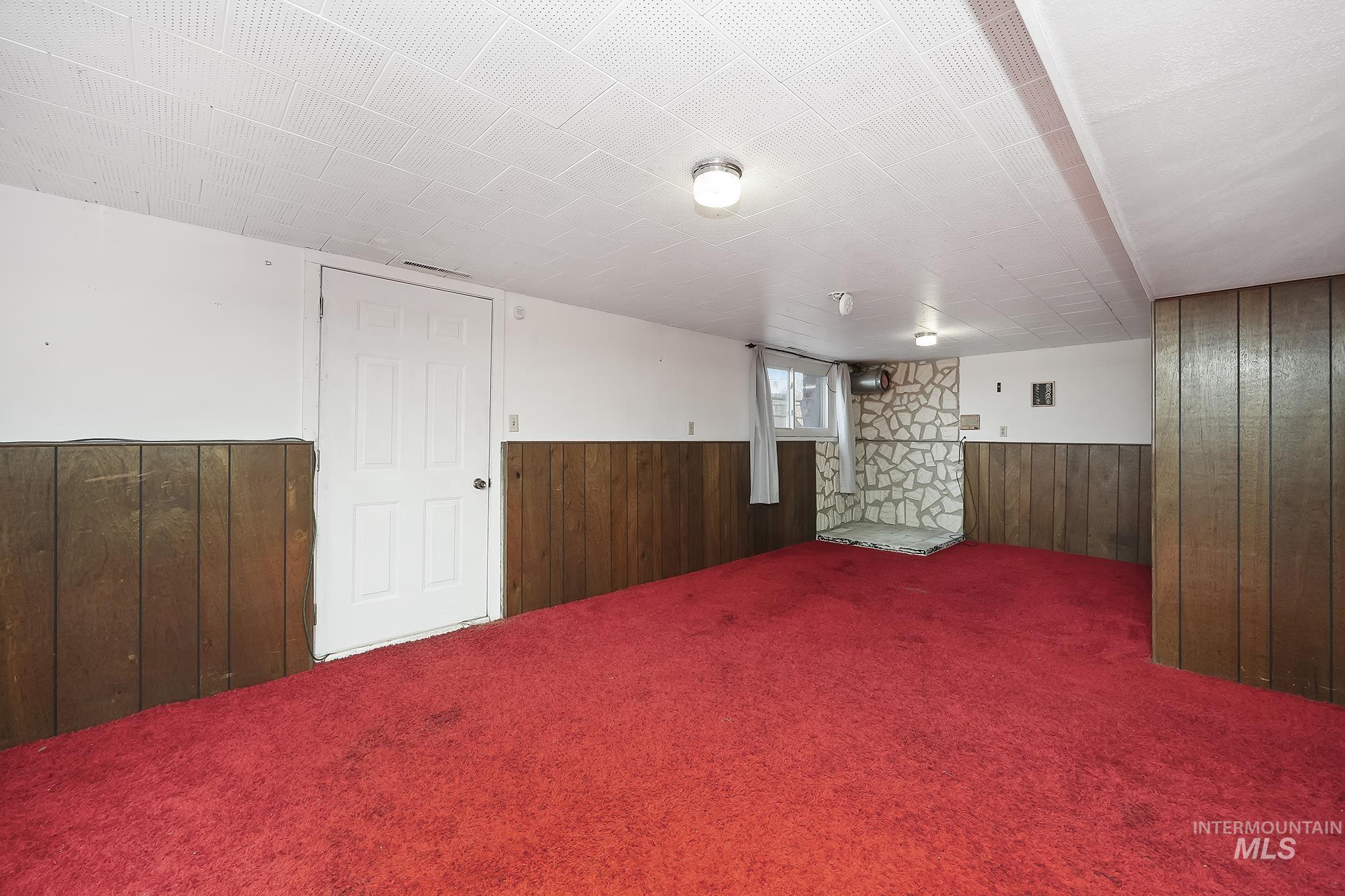 320 East 23rd Drive Burley, ID 83318 - Photo 25 of 34 Below grade area with wood walls, carpet, and wainscoting