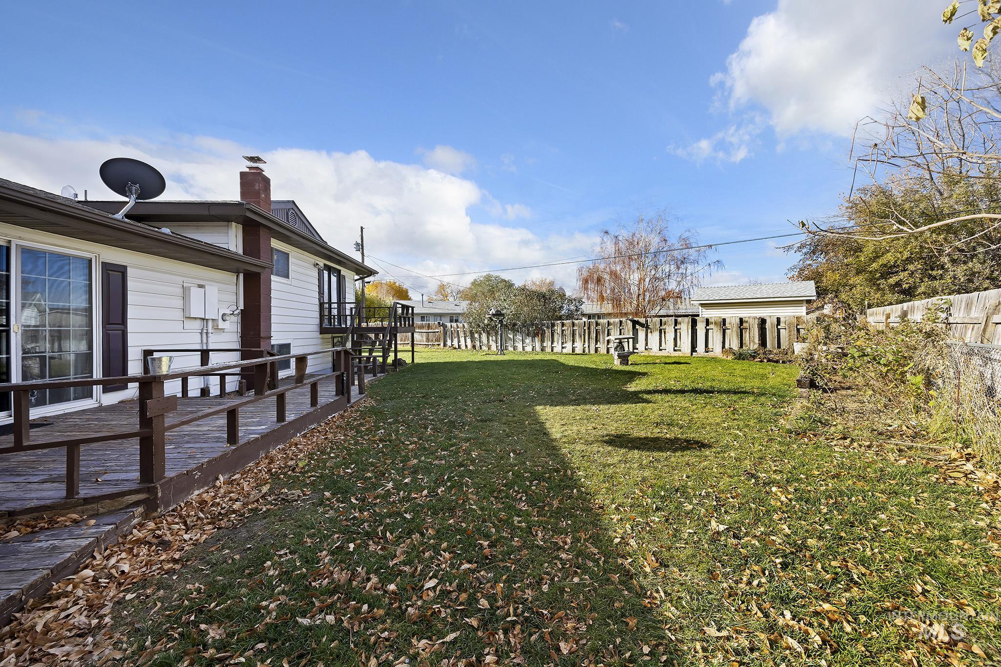 320 East 23rd Drive Burley, ID 83318 - Photo 32 of 34 Fenced backyard featuring a wooden deck