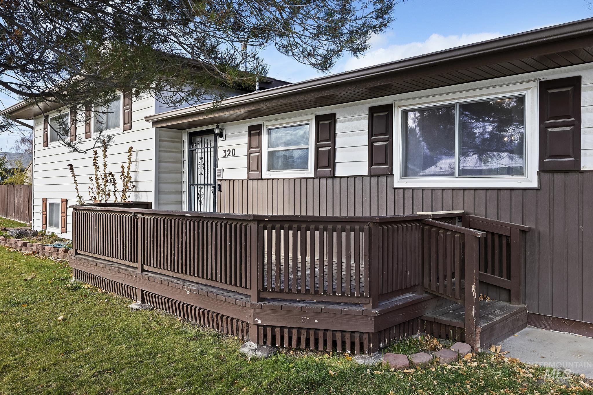 320 East 23rd Drive Burley, ID 83318 - Photo 4 of 34 Doorway to property with a wooden deck and board and batten siding