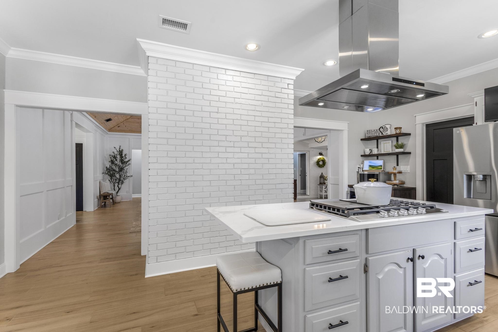 83 Caisson Trace Daphne, AL 36527 - Photo 20 of 63 Kitchen island with a built-in gas cooktop, stainless steel range hood, and white countertop