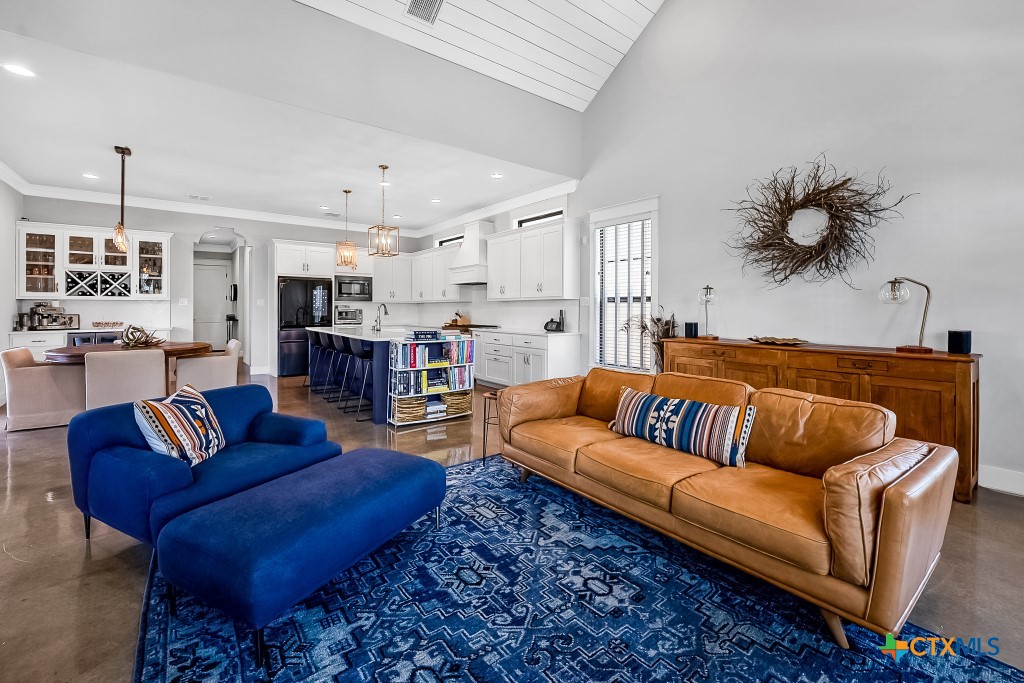 659 Prospect Way New Braunfels, TX 78130 - Photo 12 of 32 a living room with furniture kitchen view and a chandelier