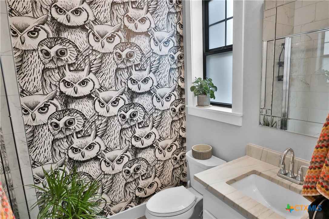 659 Prospect Way New Braunfels, TX 78130 - Photo 20 of 32 a bathroom with a toilet and a sink