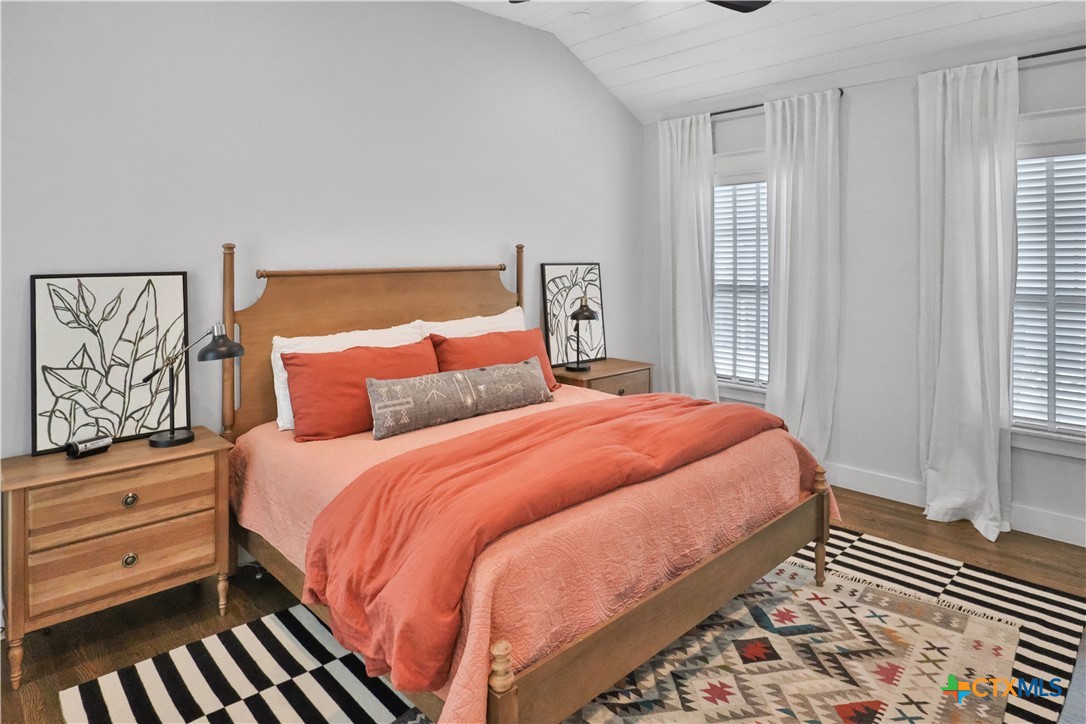 659 Prospect Way New Braunfels, TX 78130 - Photo 21 of 32 a bedroom with a bed and wooden floor