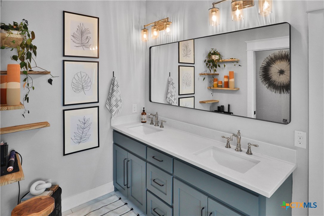 659 Prospect Way New Braunfels, TX 78130 - Photo 23 of 32 a bathroom with double vanity sink and a mirror