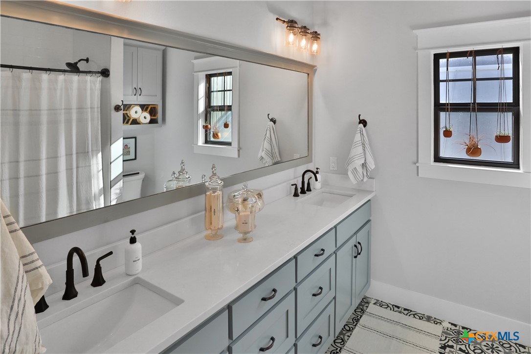 659 Prospect Way New Braunfels, TX 78130 - Photo 25 of 32 a bathroom with a sink and a mirror