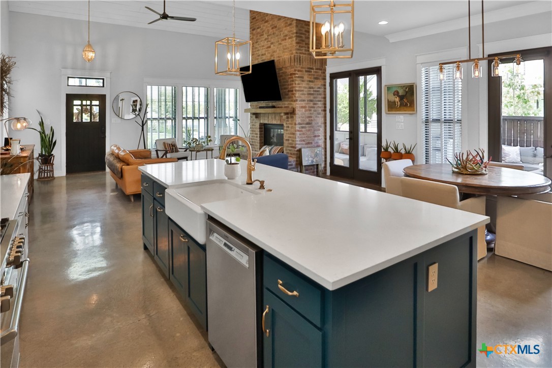 659 Prospect Way New Braunfels, TX 78130 - Photo 5 of 32 a kitchen with a stove a counter top space and living room view