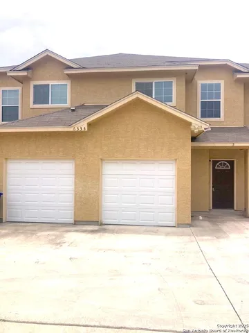 a front view of a house with a garage
