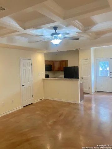 en empty room with wooden floor and ceiling fan