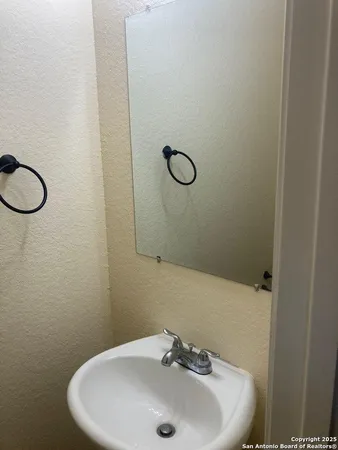 a bathroom with a sink and mirror