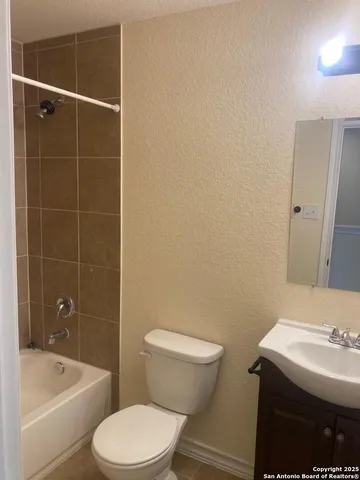a bathroom with a sink a toilet and bathtub