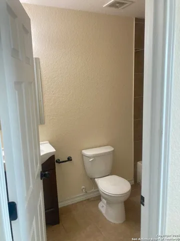 a white toilet sitting next to a small sink