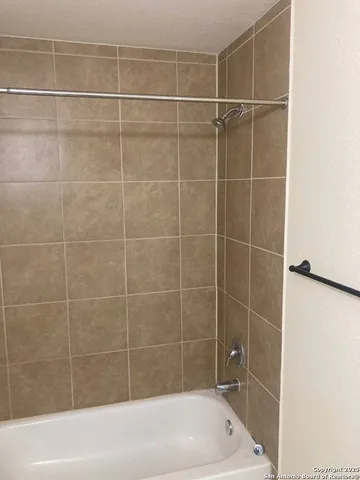 a bathroom with a shower and a bathtub