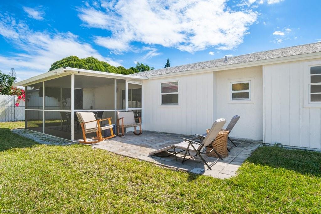 1207 Hernando Street Naples, FL 34103 - Photo 31 of 37 a view of a backyard with chair and tables