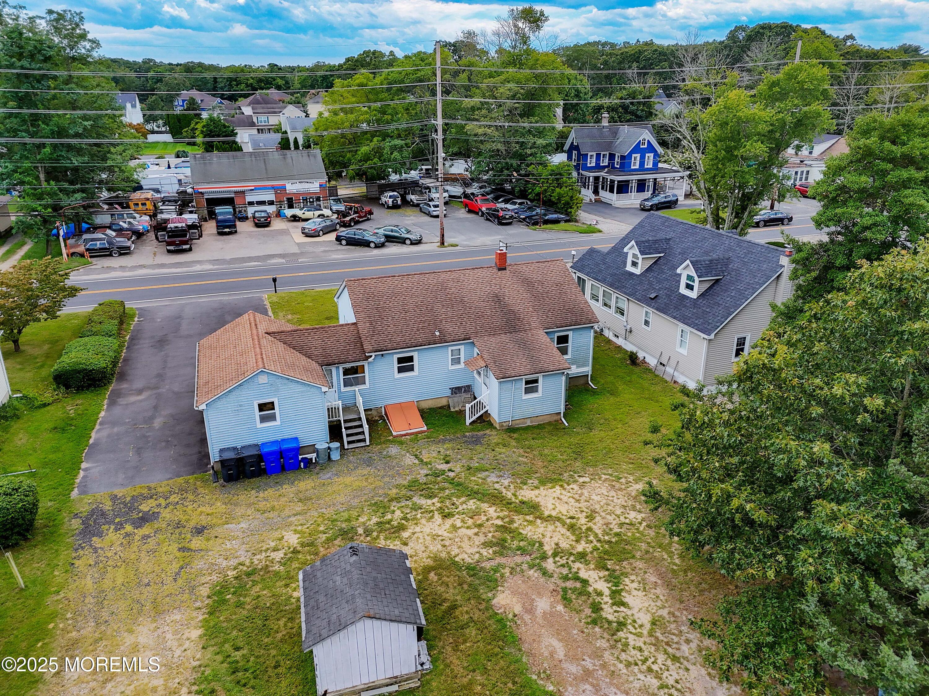 an aerial view of a house with a garden and mountain view