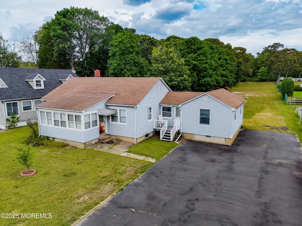 a aerial view of a house with yard and balcony