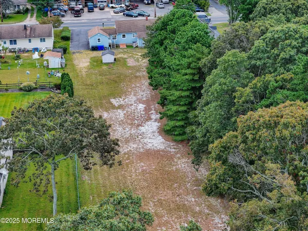 an aerial view of a houses with yard