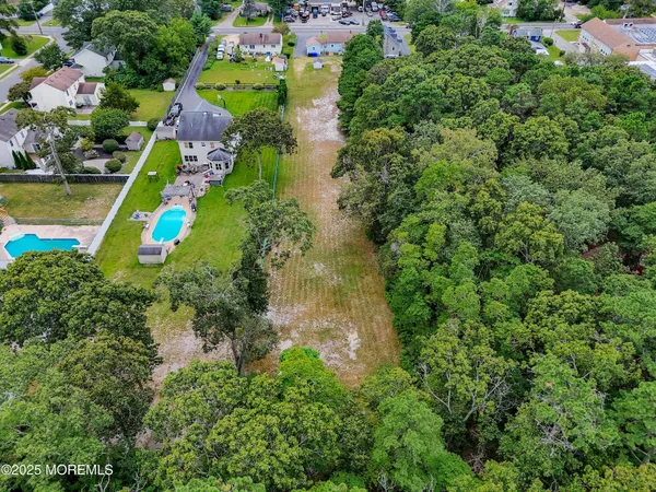 an aerial view of residential house with outdoor space and swimming pool