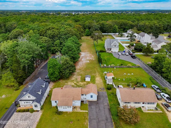 an aerial view of house with yard swimming pool and outdoor seating