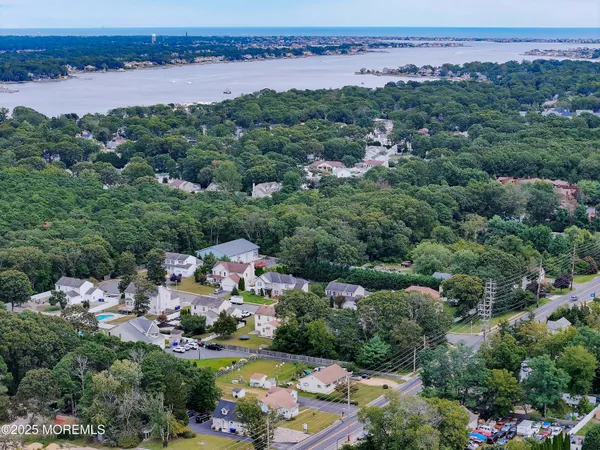 an aerial view of a city with lots of residential buildings ocean and mountain view