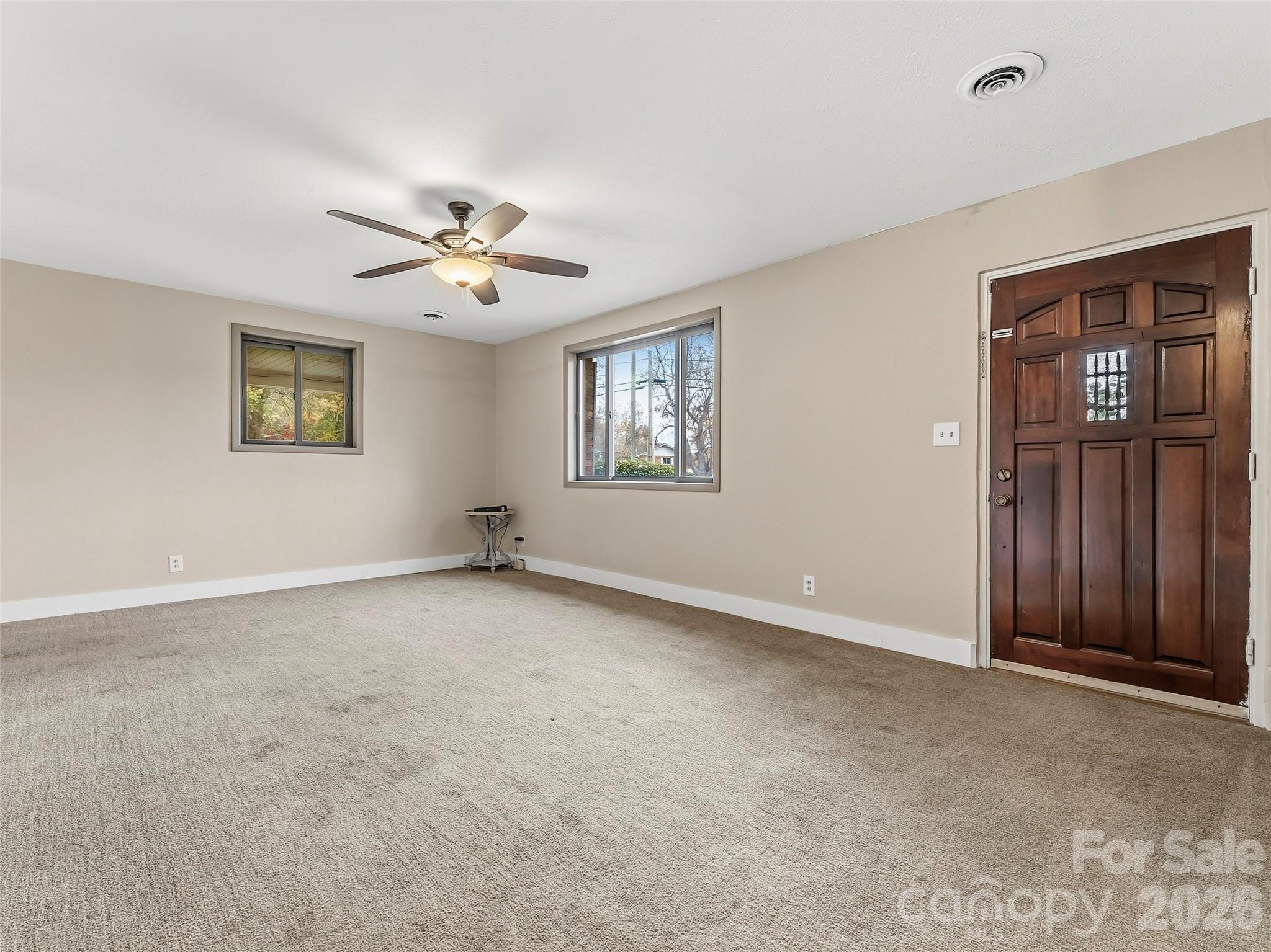 605 Dana Road Hendersonville, NC 28792 - Photo 12 of 38 a view of an empty room with window and ceiling fan